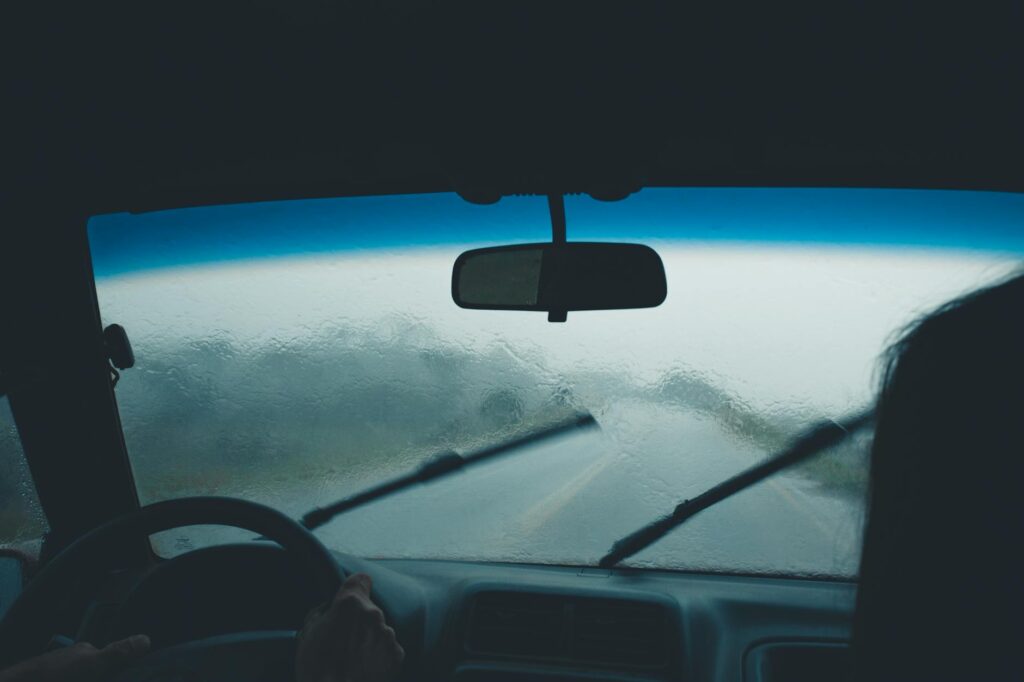 A driver checking their vehicle's tires and windshield wipers before hitting the road. — weather towing Las Vegas holidays