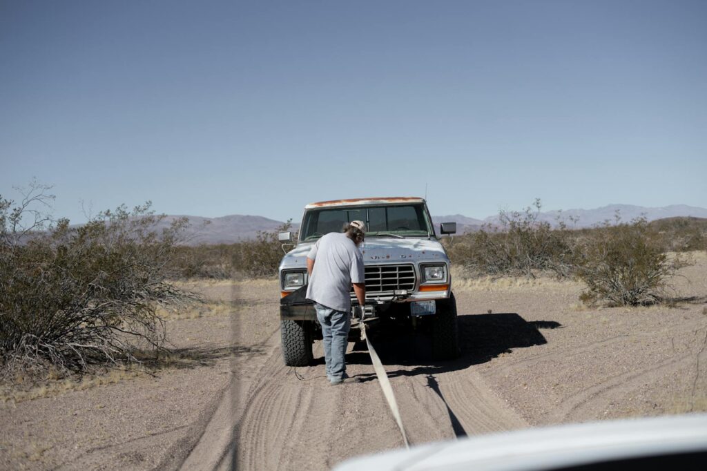 A snowy landscape in Las Vegas with a tow truck responding to a stranded vehicle. — weather towing Las Vegas holidays