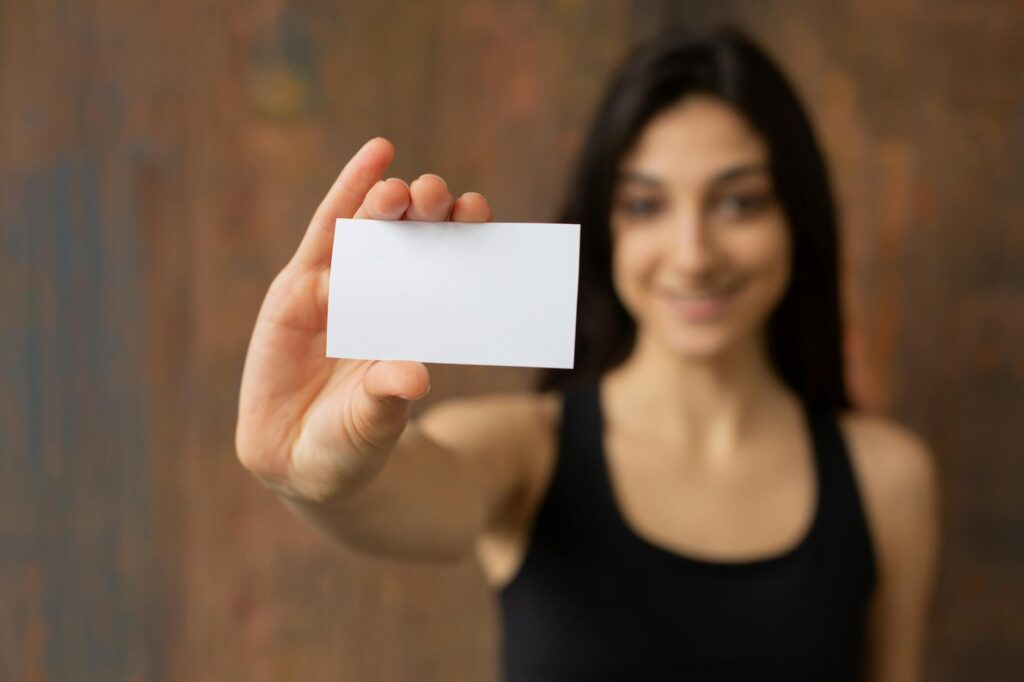 A close-up of a towing service business card with contact information — emergency towing Las Vegas