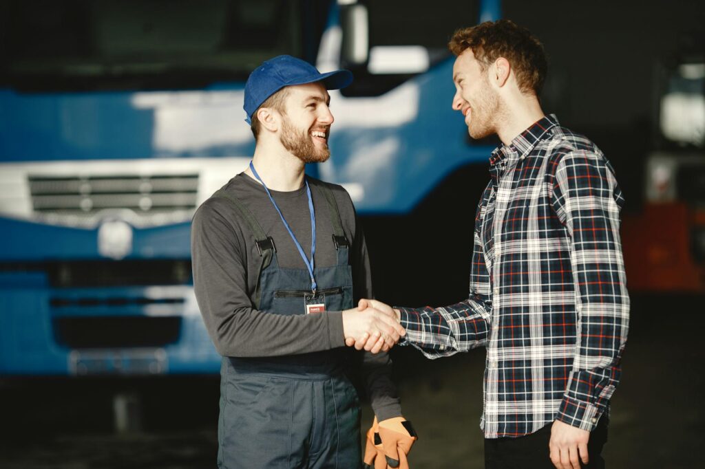 A satisfied customer and a tow truck driver shaking hands after service completion. — low-cost towing services Las Vegas
