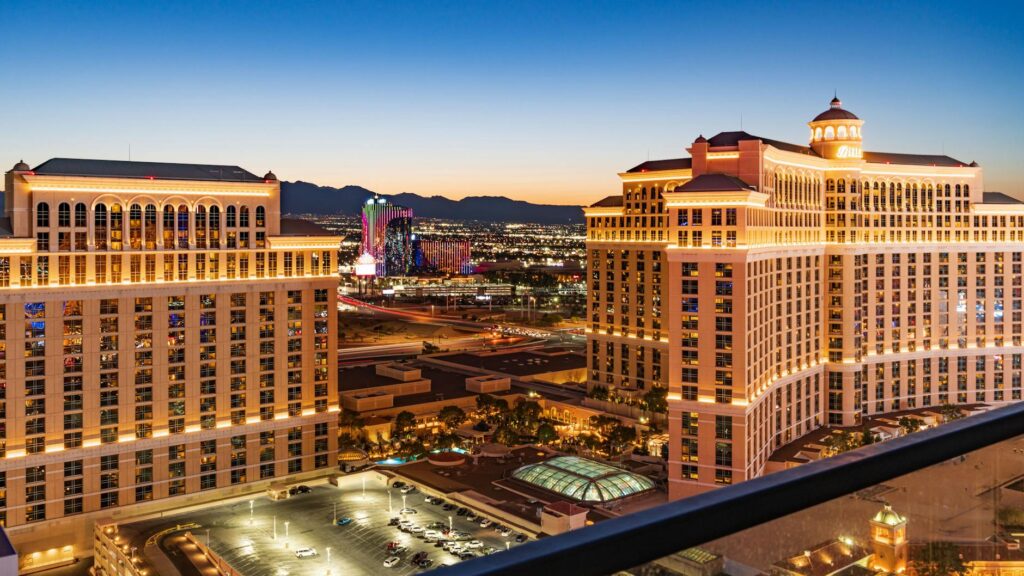 An image showing a Las Vegas skyline with a tow truck in the foreground, illustrating cheap vs premium towing Las Vegas