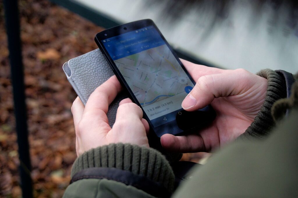 A close-up of a smartphone displaying a towing app, showcasing technology in finding cheap towing options. — save money …
