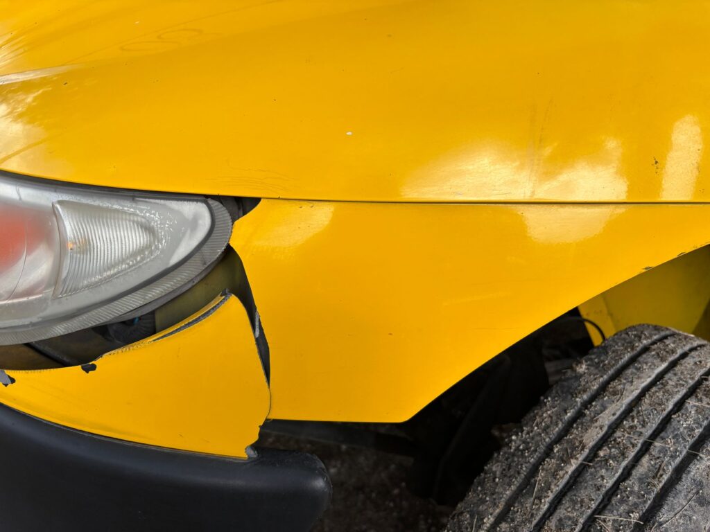 A close-up photograph of vehicle damage, highlighting areas that may be important for insurance claims. — vehicle breakd…
