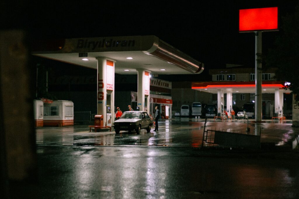 A customer receiving a gas refill roadside on a busy street. — fuel delivery las vegas