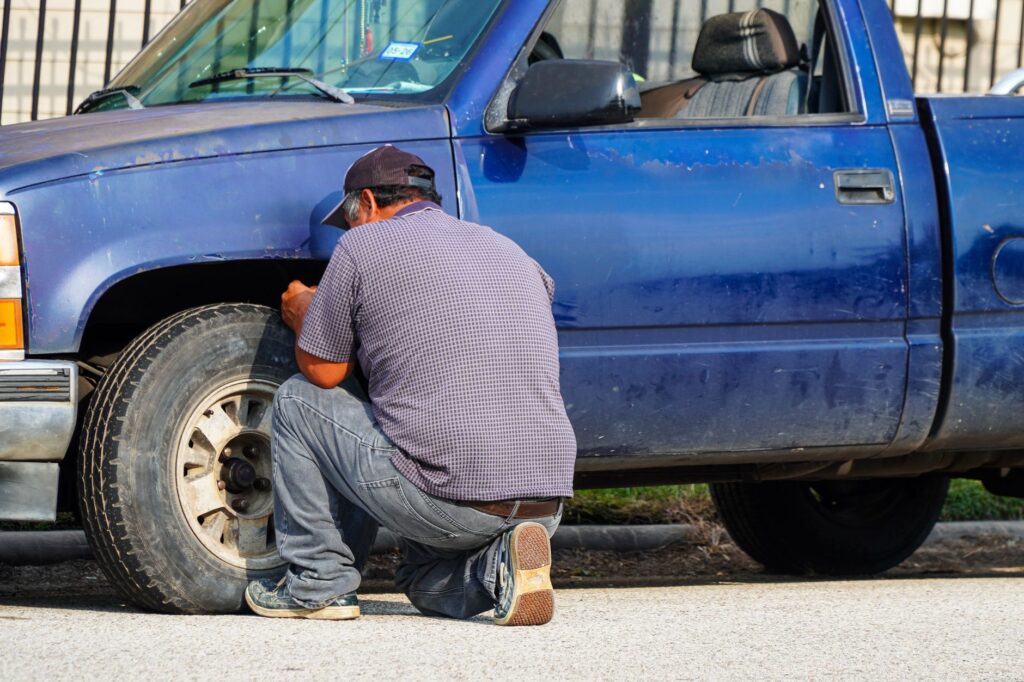 A flat tire being fixed with emergency tools at the roadside. — emergency towing Las Vegas