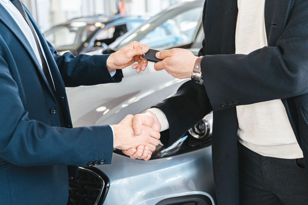 A happy customer shaking hands with a tow truck driver, symbolizing successful negotiation. — save money on towing Las V…