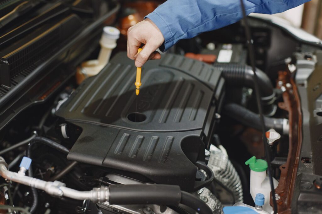 A mechanic checking the coolant levels in a vehicle. — car overheating las vegas