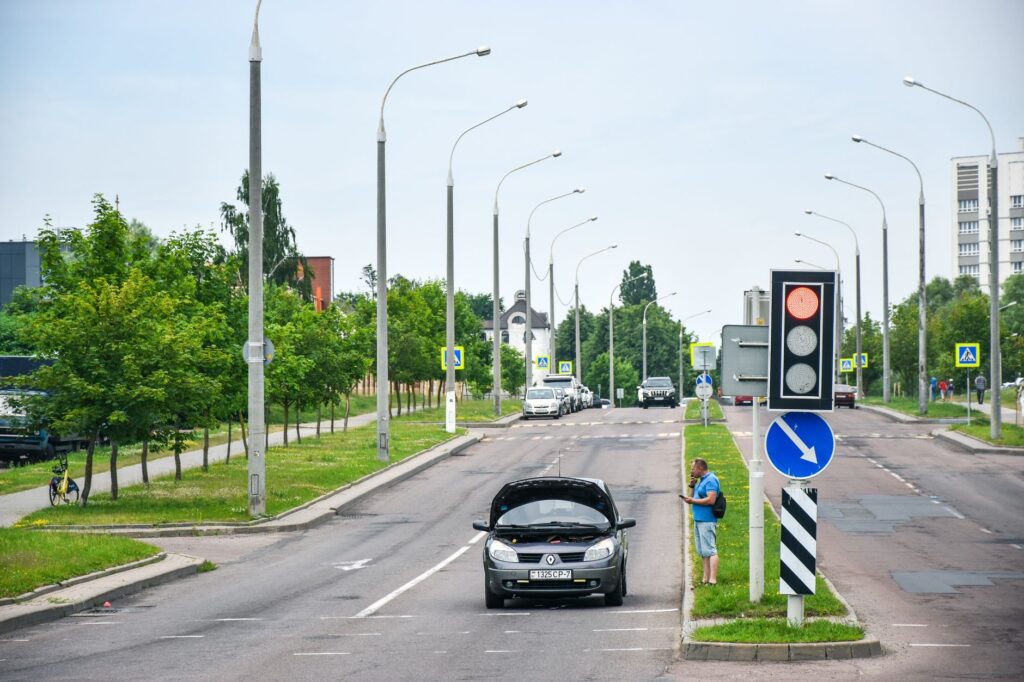 A roadside assistance vehicle helping a stranded motorist with dead battery assistance.