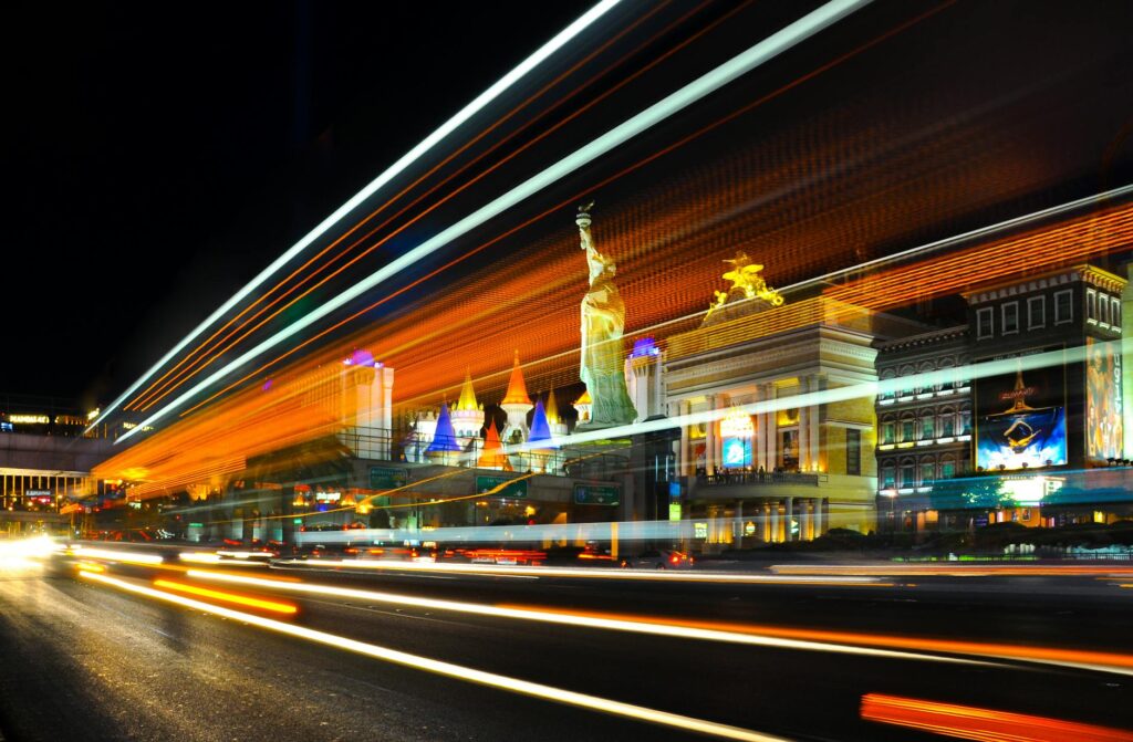 A tow truck on the Las Vegas Strip with bright neon lights in the background. — choose cheap towing company Las Vegas