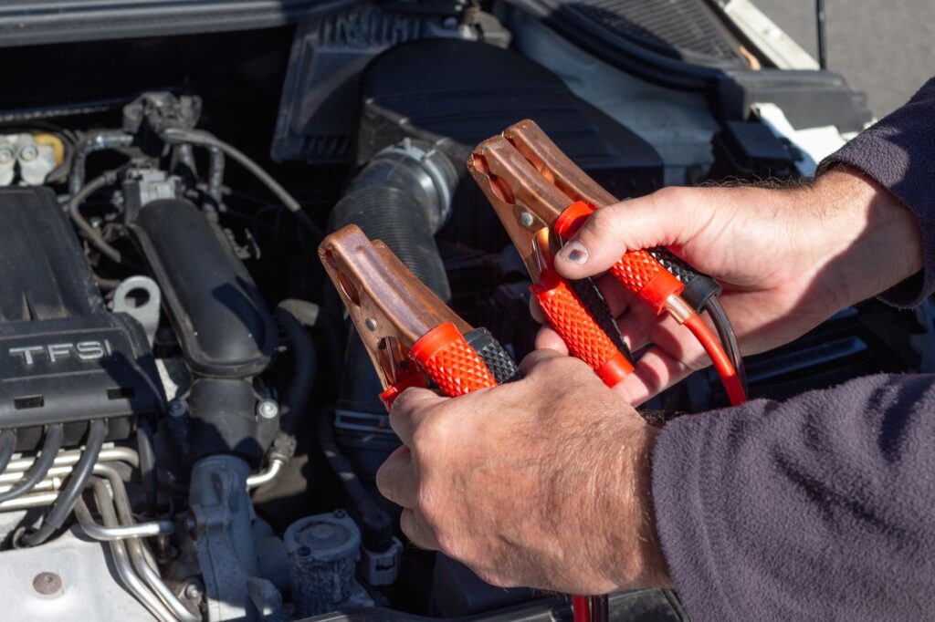 A Nevada driver using jumper cables on the roadside. — emergency car kit