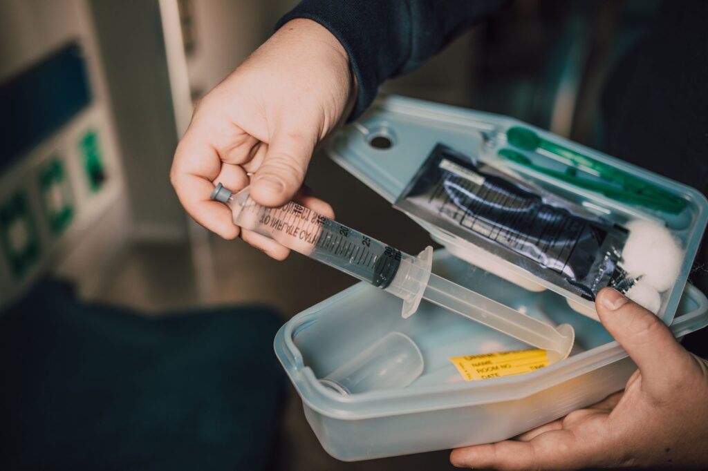 Close-up of essential emergency driving supplies like a first aid kit and flashlight. — emergency car kit