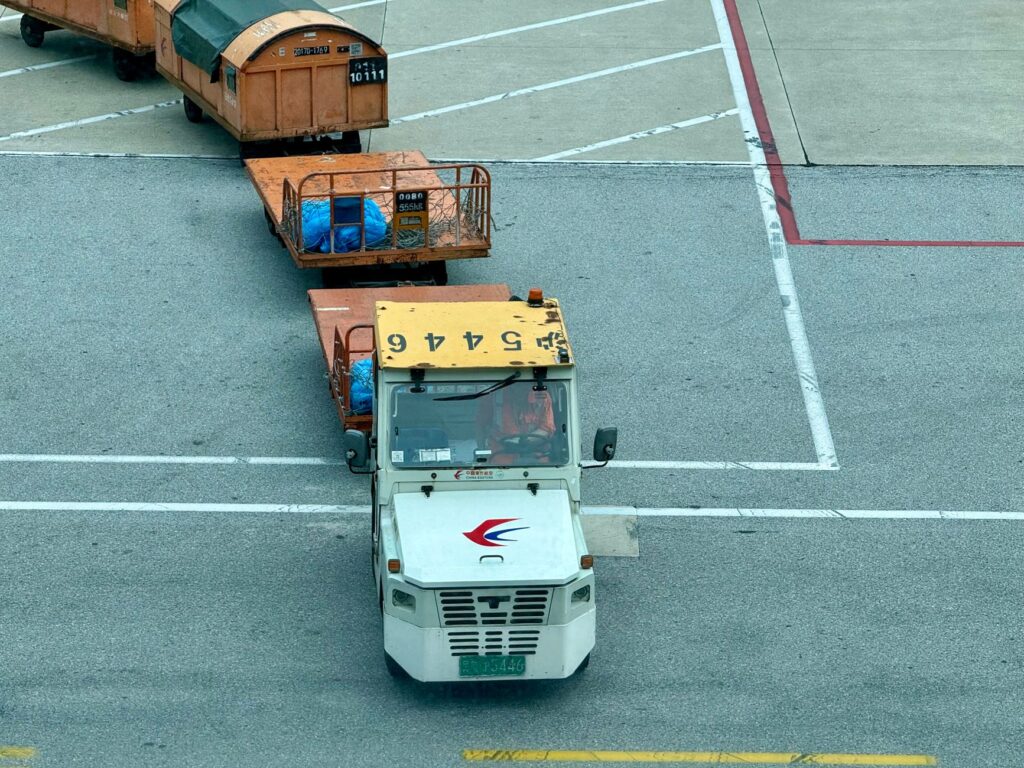 Image of a tow truck near Harry Reid Airport with a clear view of the terminal. — towing near airport las vegas