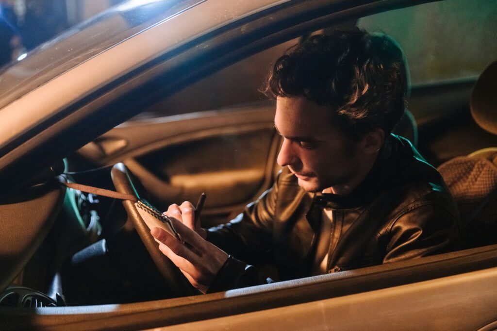 Picture of a driver taking notes and documenting the accident — car accident las vegas towing